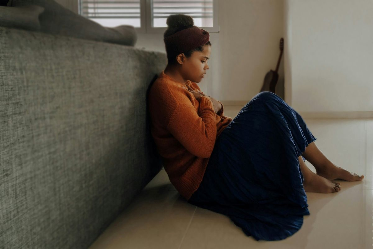 Yorkshire Counselling Services - a-black-lady-sitting-on-her-bedroom-floor-feeling-depressed